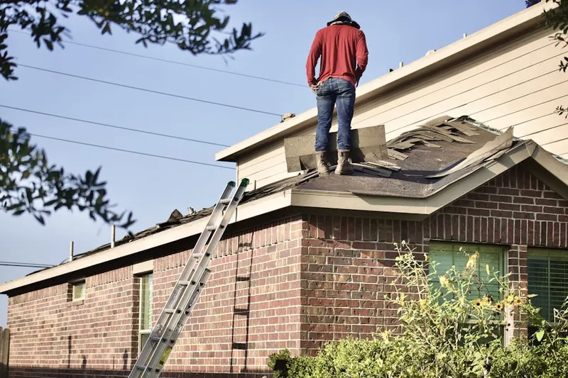 Professional roofer working on a residential roof in Kronenwetter